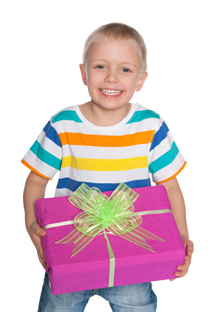 Laughing young boy with a gift box - 写真・画像