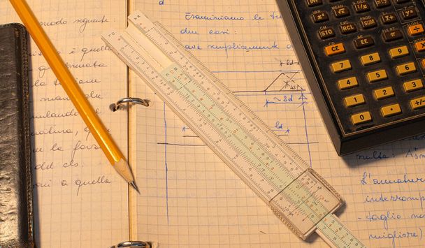 Lápis, régua velha da corrediça e página eletrônica científica da calculadora com os cálculos no progresso - Foto, Imagem