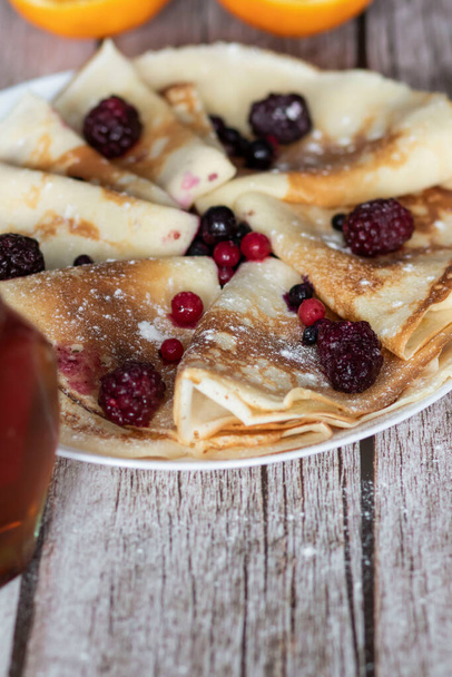 Homemade pancakes, delicious thin pancakes with berries and maple syrup - Fotografie, Obrázek