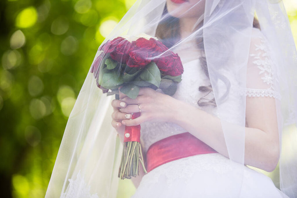 Wedding bouquet in the hands of the bride - Foto, imagen
