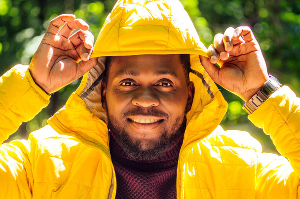 african american man in yellow jacket with a hood and dreadlocks pigtails - Photo, Image