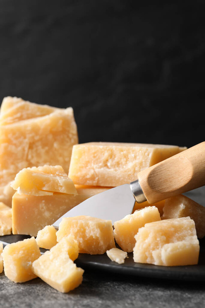 Parmesan cheese with board and knife on grey table, closeup - Foto, immagini