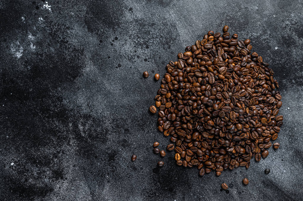 Roasted coffee beans on rustic table. Black background. Top view. Copy space - Photo, Image