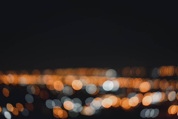 Abstract multicolored defocused lights night city. - Фото, зображення