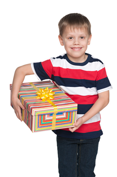 Cute little boy holds a gift box - Фото, изображение