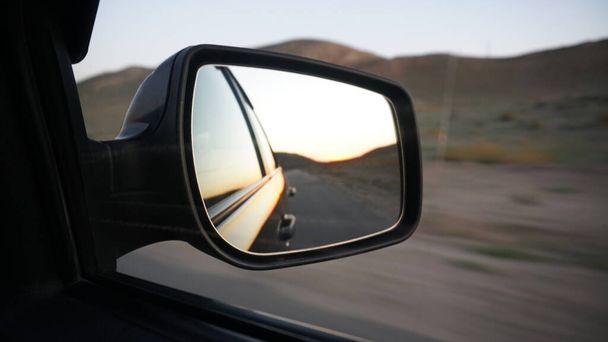 https://cdn.create.vista.com/api/media/small/446554244/stock-photo-view-side-mirror-car-orange-dawn-hills-car-going-high