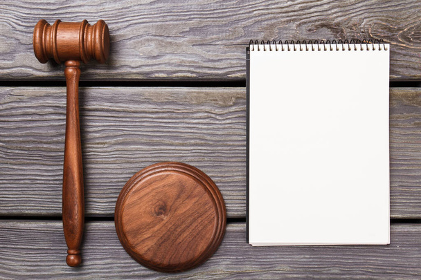 Wooden gavel and blank notpad. - Photo, Image