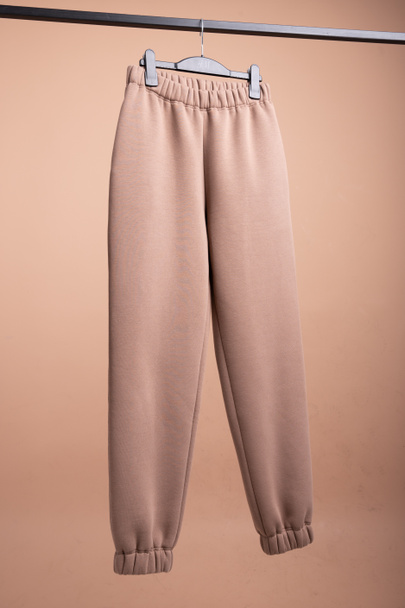 Brown sweatpants. hanging on a hangernts. High quality photo - Photo, image