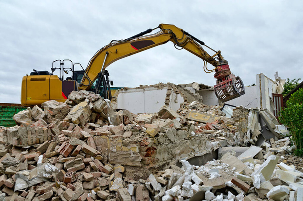 demolition of a residential house by a digger with a picker arm on a mountain of rubble in Austria - Photo, Image