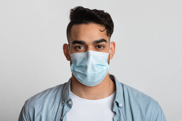 Closeup Portrait Of Young Arab Man In Protective Medical Mask On Face - Valokuva, kuva