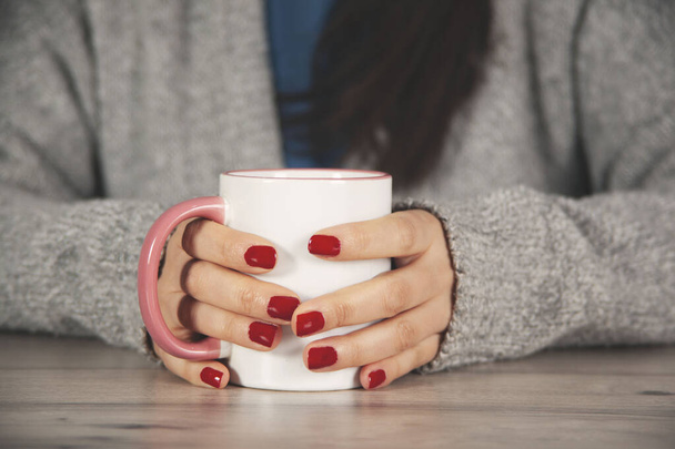  woman hand cup of coffee on the desk - 写真・画像