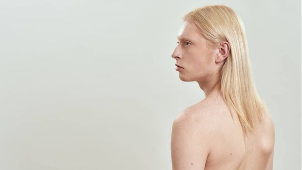 Young caucasian long haired blond shirtless man sideways - Photo, Image