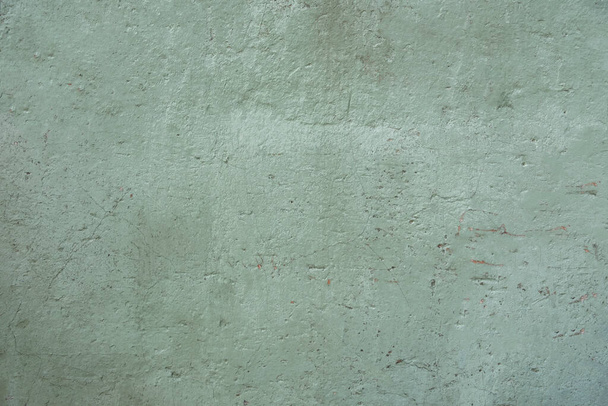 stary, stary, zielony betonowy mur z rysami. szorstka faktura powierzchni - Zdjęcie, obraz