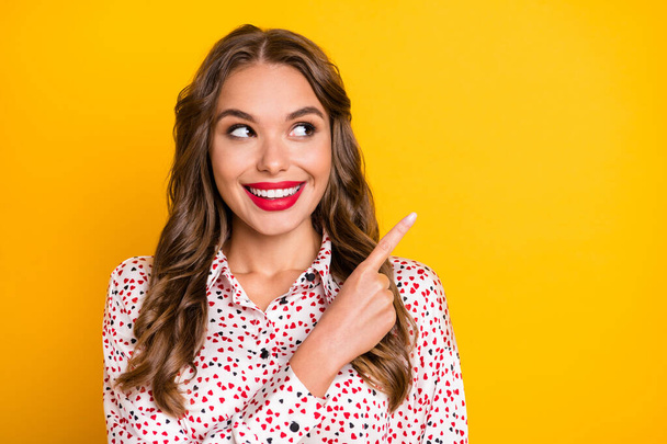 Portrait of adorable person look direct finger empty space beaming smile isolated on yellow color background - Φωτογραφία, εικόνα