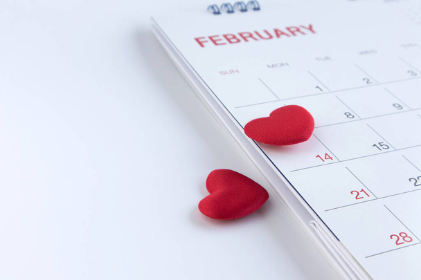 Red hearts on February 14 of Valentines day calendar page.Copy space. - Zdjęcie, obraz