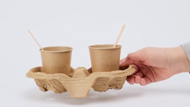 two brown paper cups stand on a cardboard stand on a white background, zero waste  - Footage, Video