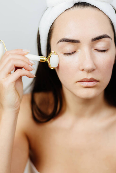 Woman using face roller For Face Massage  - Photo, Image
