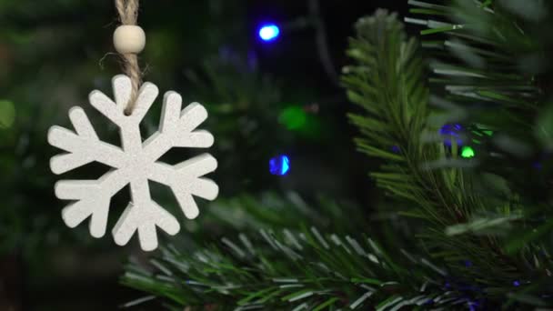 Christmas fir tree, garlands and Christmas toy in the form of a snowflake - Footage, Video