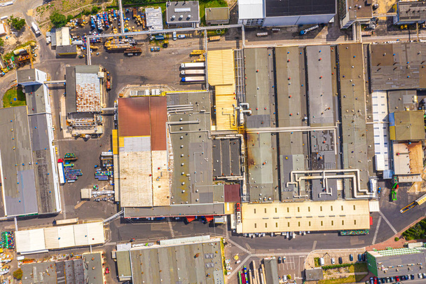 Aerial view of goods warehouse. Logistics delivery center in industrial city zone from above. Aerial view of trucks loading at logistic center. View from drone. - Фото, зображення