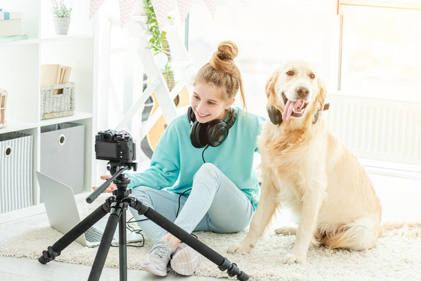 Cute teenage girl with dog blogging - Фото, зображення