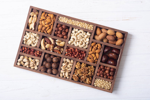 Mix of nuts in box . Healthy vegetarian food background photo - 写真・画像