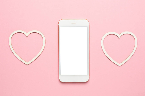 Modern mobile phone with hearts, social distancing and dating concept, valentines day mock up, copy space on display top view - Photo, Image