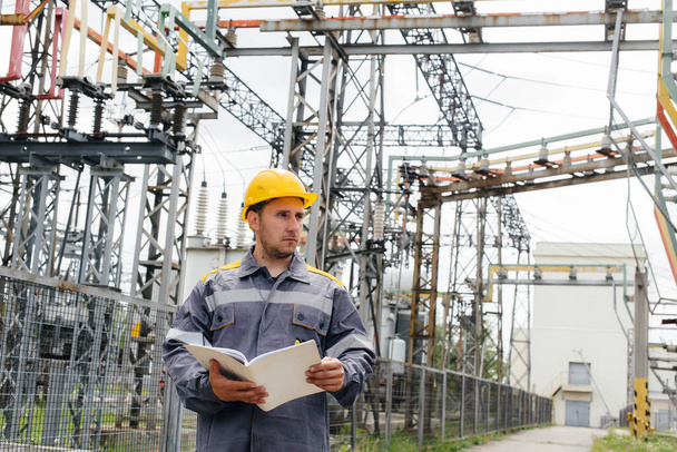 The energy engineer inspects the equipment of the substation. Power engineering. Industry - Photo, image