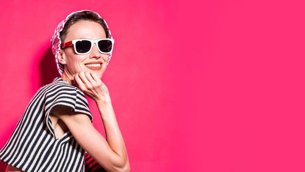  Female fashion model posing in striped clothes, wearing hat and sunglasses - 写真・画像