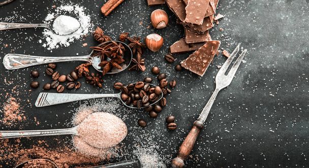 Sweet ingredients and chocolate on a table - Фото, изображение