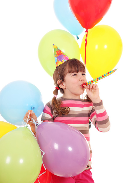 happy little girl with trumpet hat and balloons birthday party - 写真・画像