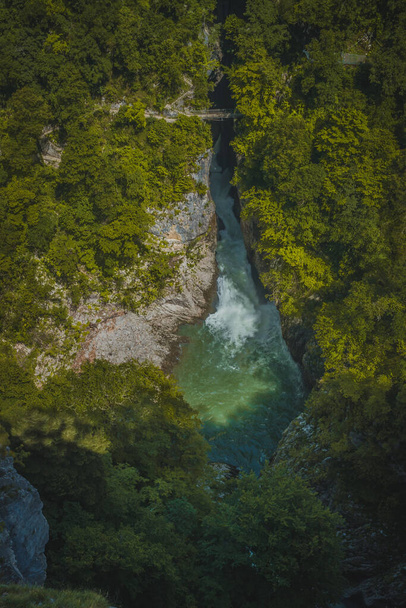 View of river Reka, flowing through UNESCO protected famous Skocjan Caves. Aerial view of the Skocjan caves with closeup of the river. - 写真・画像