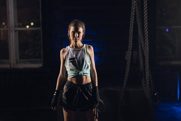 Young girl stands in an atmospheric gym. Sport - Photo, Image