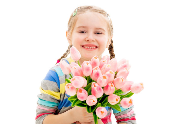 Young kid with a bouquet of spring flowers - Foto, imagen