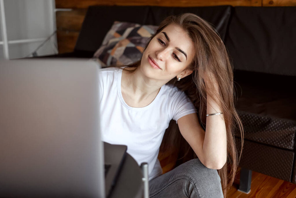 Pretty girl student watch webinar, listen online course, communicate by conference video call e-learn, study with teacher lesson look in laptop at home. Close up - Fotografie, Obrázek