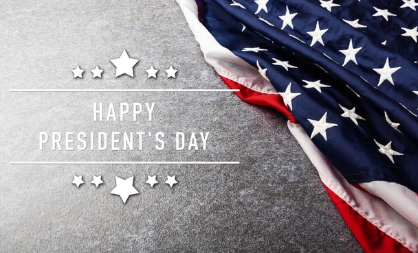 United States National Holidays. American or USA Flag with "HAPPY PRESIDENT'S DAY" text on cement background, President Day concept - Fotó, kép
