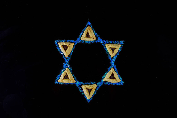 Jewish holiday background with hamantaschen cookies and star of David for Purim. - Photo, Image