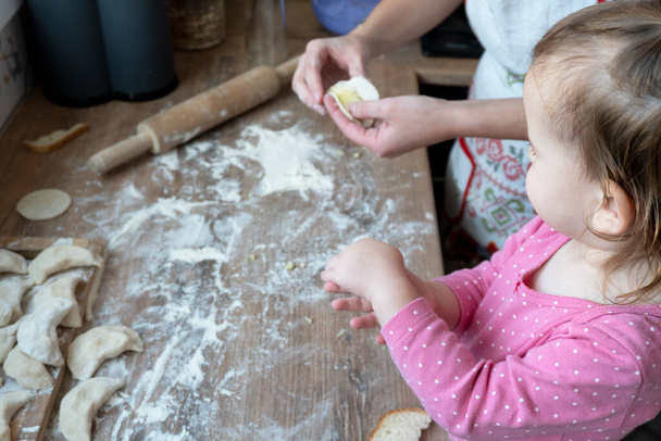 Cute little caucasian child looking how to make vareniki - Fotografie, Obrázek