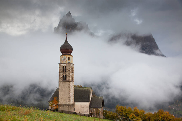 san Valentino church on a foggy late autumn day, Siusi allo Sciliar, Castelrotto, Dolomites, Italy - Photo, Image