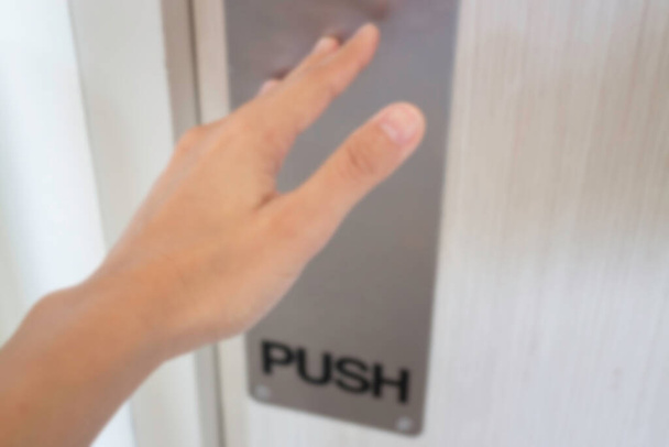 Woman hand pushing the door, stock photo - Photo, image