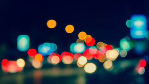 vintage tone image of blur street bokeh with colorful lights in night time for background usage . - Photo, Image