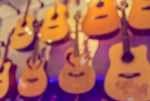 Abstract Blurred image of musical instrument shop with bokeh for backgrund usage . (vintage tone) - Photo, Image