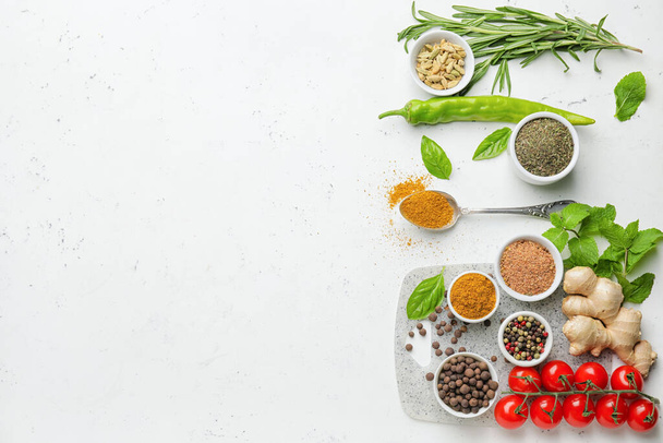 Composition with different spices and herbs on light background - Photo, Image