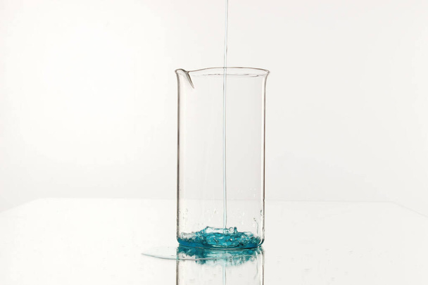 A plastic beaker isolated on a white background - Φωτογραφία, εικόνα