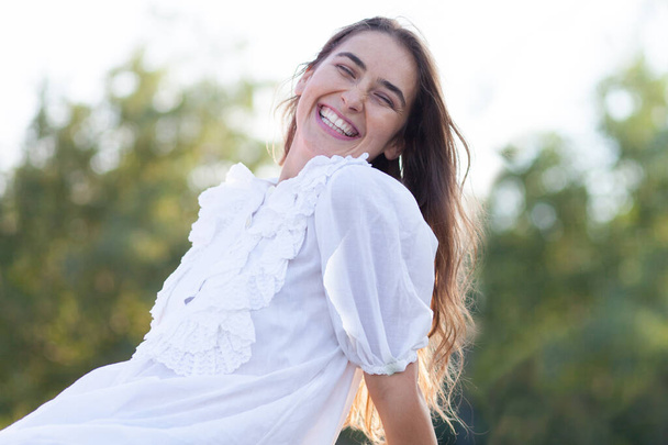 smiling hipster girl in white dress - Foto, afbeelding