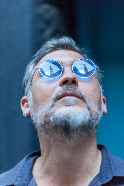 portrait of a man with sunglasses looking up - Photo, Image