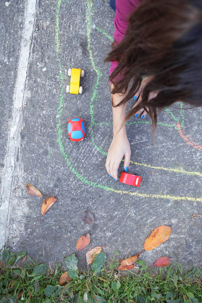 kid playing with small car toys on the playground - Foto, Imagen