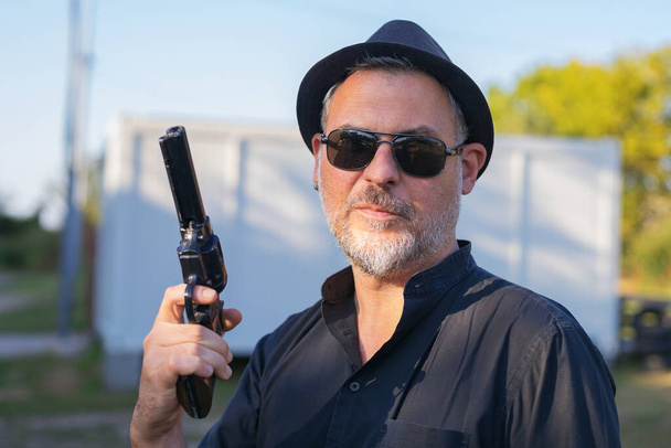 portrait of a man holding a gun replica - Photo, Image