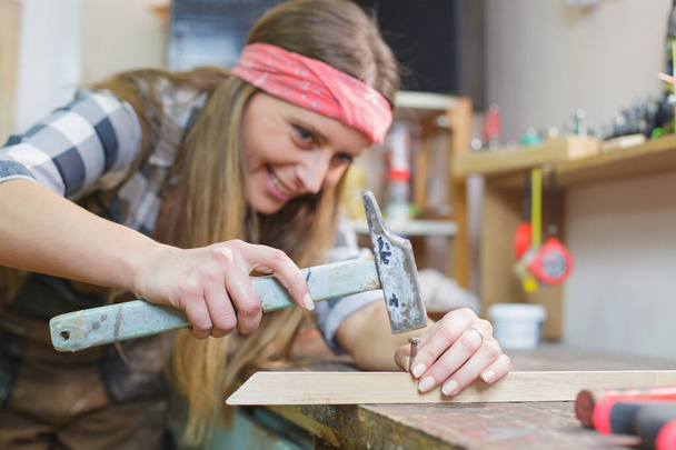 young woman working in workshop - Φωτογραφία, εικόνα