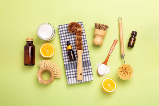 Eco friendly cleaning products and tools. Wooden bamboo brushes, baking soda, lemon, essential oils, vinegar. Top view - Zdjęcie, obraz