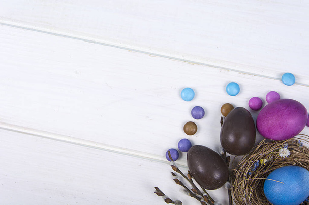 Colorful background with Easter eggs on white wooden board background. Happy Easter concept. Can be used as poster, background, holiday card. Srudio Photo - Photo, Image